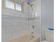 Tiled shower and tub combination with upgraded shower head fixture and neutral colored tile work at 778 2Nd St, Firestone, CO 80520