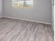Well-lit bedroom featuring luxury vinyl plank flooring and neutral wall colors at 778 2Nd St, Firestone, CO 80520