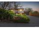 Charming home with mature landscaping, warm exterior lighting, and an attached garage, creating inviting curb appeal at 778 2Nd St, Firestone, CO 80520
