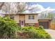 Inviting home featuring a well-manicured lawn, mature bushes, and a two-car garage for ample parking at 778 2Nd St, Firestone, CO 80520
