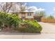 Charming home featuring a well-manicured lawn, mature bushes, and a two-car garage for ample parking at 778 2Nd St, Firestone, CO 80520