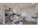 Modern kitchen featuring white cabinets, stainless steel appliances, and a sleek island with barstool seating at 778 2Nd St, Firestone, CO 80520