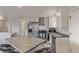 Bright kitchen features stainless steel appliances, an island with seating, and white cabinets against light gray walls at 778 2Nd St, Firestone, CO 80520