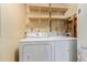 Laundry area with washer, dryer, and open shelving at 778 2Nd St, Firestone, CO 80520
