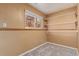 This carpeted storage area has open shelving at 778 2Nd St, Firestone, CO 80520