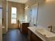 Modern bathroom with double vanity and large shower at 39110 E 146Th Ct, Keenesburg, CO 80643