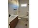 Bathroom with a soaking tub, double vanity, and modern fixtures at 39110 E 146Th Ct, Keenesburg, CO 80643