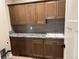 Laundry room with wood cabinets and granite countertop at 39110 E 146Th Ct, Keenesburg, CO 80643