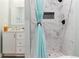 Elegant bathroom featuring marble-style tile shower, stylish fixtures, and vanity at 9 N Waterloo St, Aurora, CO 80018