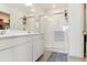 Bright bathroom featuring double sink vanity, enclosed walk-in shower, and ample storage at 9 N Waterloo St, Aurora, CO 80018