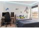 Themed bedroom featuring Detroit Lions decor, gaming setup, and comfortable bed at 9 N Waterloo St, Aurora, CO 80018