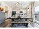 Open-concept dining area with a wooden table, stylish seating, and sliding glass doors for natural light at 9 N Waterloo St, Aurora, CO 80018