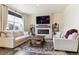 Cozy living room featuring a modern fireplace, comfortable seating, and hardwood floors at 9 N Waterloo St, Aurora, CO 80018