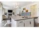 Open concept living and dining area with granite kitchen island and a modern fireplace at 9 N Waterloo St, Aurora, CO 80018