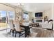 Open-concept living and dining area featuring hardwood floors, a fireplace, and ample natural light at 9 N Waterloo St, Aurora, CO 80018