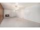 Finished basement with cozy fireplace, neutral carpet, and white paneled walls at 805 S Everett St, Lakewood, CO 80226