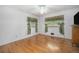 Bedroom with hardwood floors, ceiling fan and bright windows with decorative curtains at 805 S Everett St, Lakewood, CO 80226