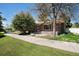 Charming brick home with a well-manicured lawn and mature tree in a quiet residential neighborhood at 805 S Everett St, Lakewood, CO 80226
