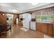 Functional kitchen featuring white appliances, wood cabinets, and view to additional living space at 805 S Everett St, Lakewood, CO 80226