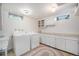 Bright laundry room with washer, dryer, utility sink, and counter space for folding and storage at 805 S Everett St, Lakewood, CO 80226