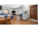 Bright living room featuring stone accents, hardwood floors, and a large window overlooking the front yard at 805 S Everett St, Lakewood, CO 80226