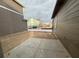 A concrete patio in a backyard and a view of other houses in the neighborhood at 2277 Serenidad St, Brighton, CO 80601