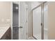 Modern bathroom featuring a glass-enclosed shower, white tile, and contemporary fixtures at 2277 Serenidad St, Brighton, CO 80601