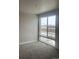 Bedroom featuring a large window, carpet, and neutral wall color at 2277 Serenidad St, Brighton, CO 80601