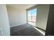 Bedroom with a large window providing ample natural light and a neutral color scheme, carpeted floor at 2277 Serenidad St, Brighton, CO 80601