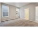 Bright bedroom featuring neutral walls, carpeted floors, and well-lit entry with two windows for natural light at 2277 Serenidad St, Brighton, CO 80601