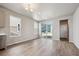 Eat in dining area with modern chandelier, tile floors and natural light streaming through a doorway and window at 2277 Serenidad St, Brighton, CO 80601