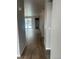 Hallway featuring wood-look flooring and neutral wall color leading into the living area at 2277 Serenidad St, Brighton, CO 80601