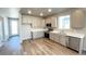 Bright kitchen with stainless steel appliances, white countertops, and wood-look flooring at 2277 Serenidad St, Brighton, CO 80601