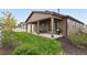 A backyard featuring a covered patio and green grass at 5670 Pinto Valley St, Parker, CO 80134