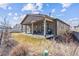 Exterior of home showing backyard with covered patio, seating, and a grill at 5670 Pinto Valley St, Parker, CO 80134