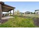 Well-maintained backyard features a covered patio and a white fence, perfect for outdoor living and privacy at 5670 Pinto Valley St, Parker, CO 80134