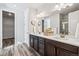 Bright bathroom featuring a double vanity with a white countertop and wood-look flooring at 5670 Pinto Valley St, Parker, CO 80134