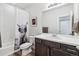 Modern bathroom featuring a vanity with a sink, toilet, tub, and shower with neutral decor at 5670 Pinto Valley St, Parker, CO 80134