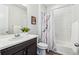 Bathroom with marble shower curtain, white tile and sleek vanity at 5670 Pinto Valley St, Parker, CO 80134