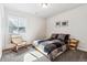 Cozy bedroom featuring a comfortable bed, chair, and natural light from the window at 5670 Pinto Valley St, Parker, CO 80134