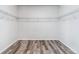 Walk-in closet with wire shelving and wood-look flooring at 5670 Pinto Valley St, Parker, CO 80134