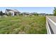 A grassy common area is surrounded by well-maintained homes and a white picket fence at 5670 Pinto Valley St, Parker, CO 80134