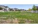 A grassy common area is surrounded by well-maintained homes and a white picket fence at 5670 Pinto Valley St, Parker, CO 80134