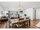 Open dining room with fireplace and large windows, seamlessly flowing into the living room at 5670 Pinto Valley St, Parker, CO 80134