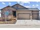 Charming single-Gathering home with three-car garage, neutral paint, stone accents, and well-maintained yard at 5670 Pinto Valley St, Parker, CO 80134