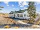 Beautiful exterior featuring white siding, a green roof, professional landscaping, and a welcoming walkway at 5670 Pinto Valley St, Parker, CO 80134