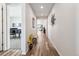 Long and bright hallway with modern decor and hardwood flooring, leading to various rooms at 5670 Pinto Valley St, Parker, CO 80134