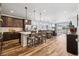 Open-concept kitchen features wood floors, stainless appliances, large island with bar seating, and easy access to a living area at 5670 Pinto Valley St, Parker, CO 80134