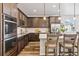 Modern kitchen with stainless steel appliances, white subway tile backsplash and center island at 5670 Pinto Valley St, Parker, CO 80134