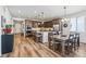 Spacious kitchen and dining area with an island, bar seating, and modern light fixtures at 5670 Pinto Valley St, Parker, CO 80134